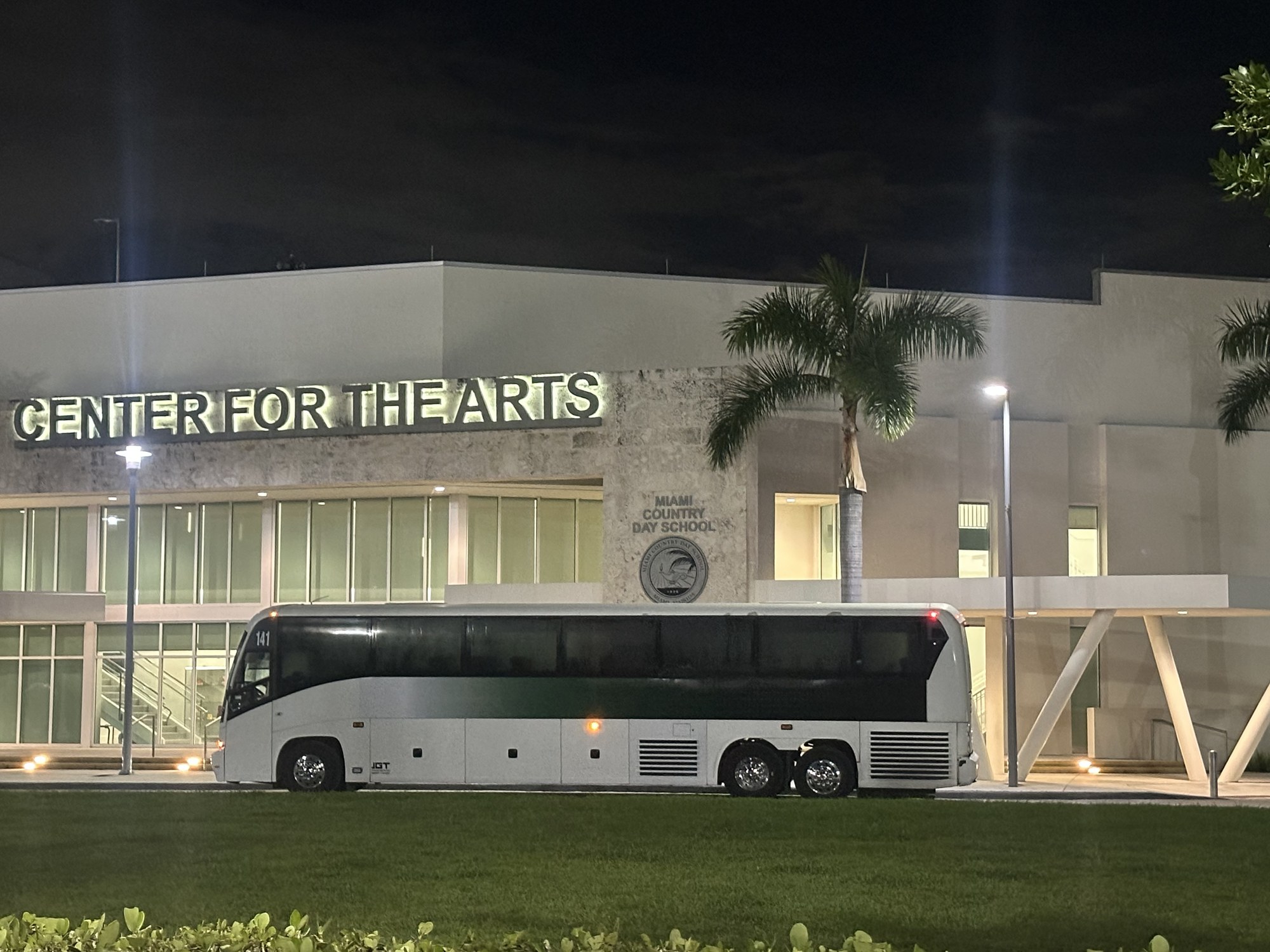 JGT coach at a venue in the evening