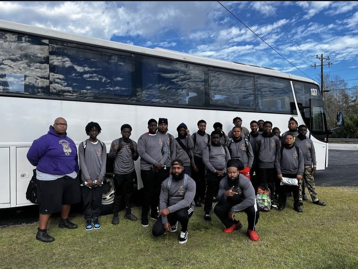 Sports team in front of a JGT coach