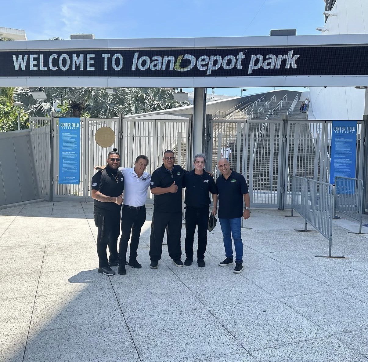JGT team standing outside LoanDepot Park